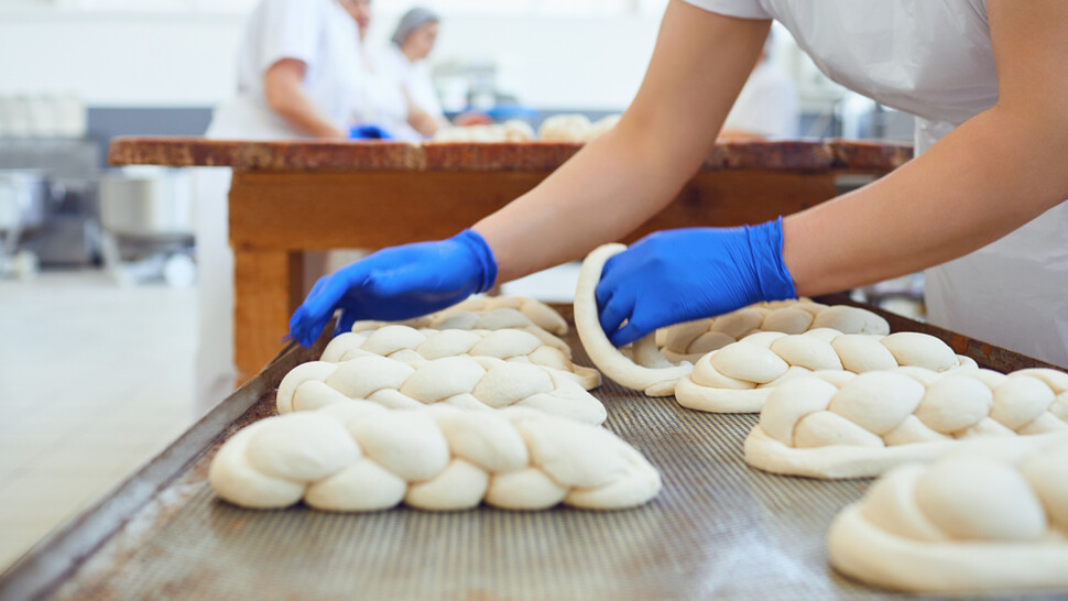 Employee working on dough in production line